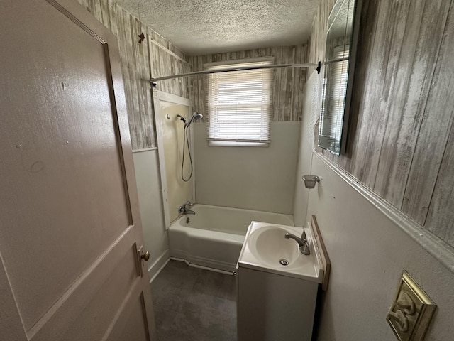 full bath featuring a textured ceiling, shower / bathtub combination, and vanity