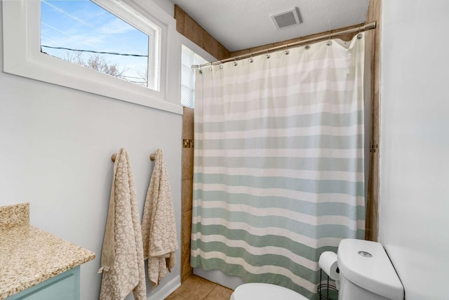 full bath with tile patterned flooring, a shower with curtain, visible vents, and toilet