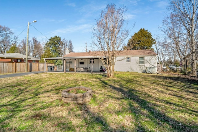 back of property with crawl space, a yard, fence, and a patio