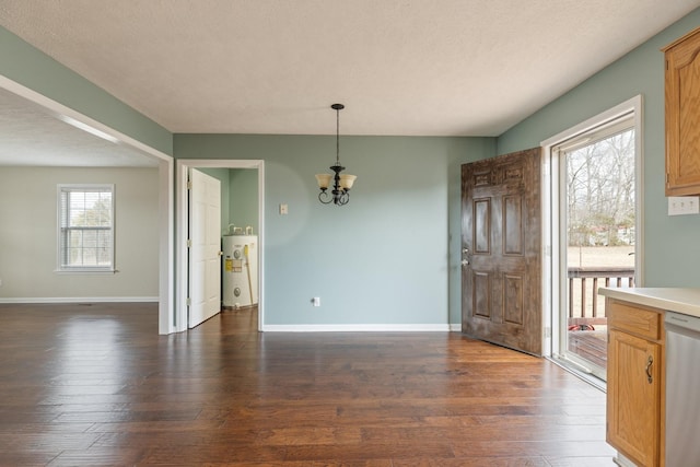 unfurnished dining area featuring dark wood-style flooring, electric water heater, a notable chandelier, and baseboards