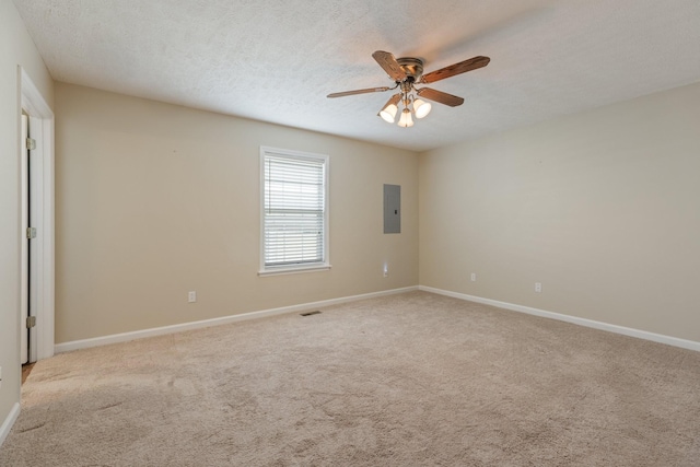 unfurnished room featuring a textured ceiling, carpet flooring, electric panel, and baseboards