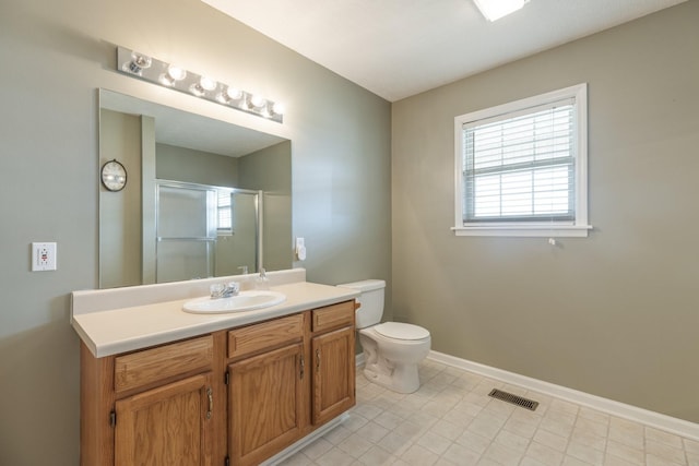 bathroom featuring visible vents, toilet, a stall shower, vanity, and baseboards