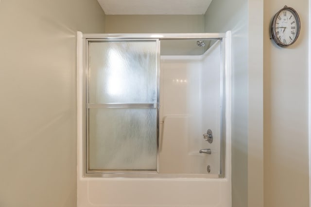 full bathroom with bath / shower combo with glass door