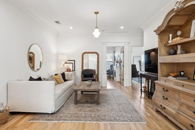 living room with light wood-style floors, recessed lighting, visible vents, and ornamental molding