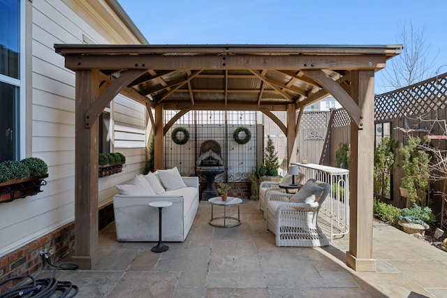 view of patio with a gazebo, outdoor lounge area, and fence