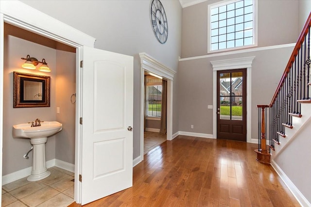 entryway featuring a healthy amount of sunlight, stairs, and wood finished floors