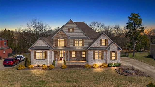 view of front of home featuring a standing seam roof, metal roof, and a lawn