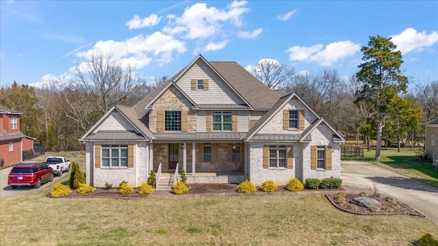 craftsman inspired home featuring a standing seam roof, metal roof, a porch, and a front yard