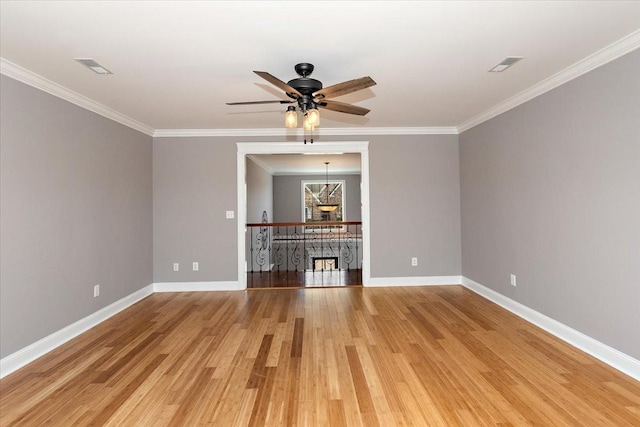 unfurnished living room with baseboards, visible vents, crown molding, and light wood finished floors