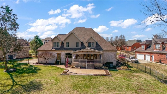 rear view of property with a yard and fence