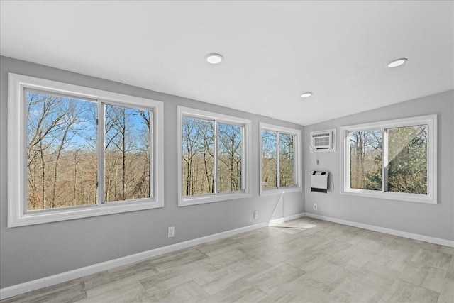 unfurnished room featuring recessed lighting, heating unit, baseboards, and a wall mounted AC