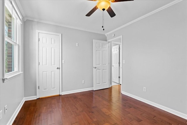 unfurnished bedroom featuring ornamental molding, baseboards, and wood finished floors