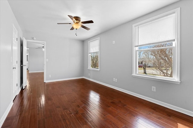 interior space with ceiling fan, baseboards, and dark wood finished floors