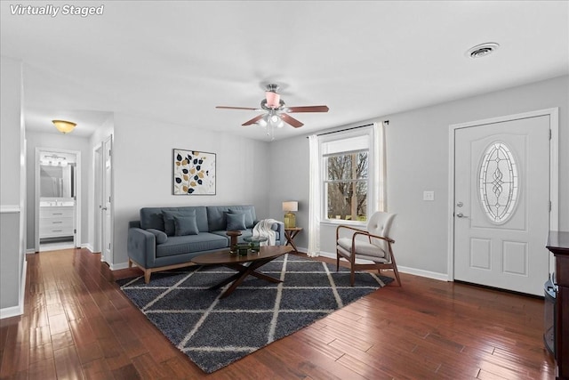 living room featuring a ceiling fan, baseboards, visible vents, and hardwood / wood-style floors