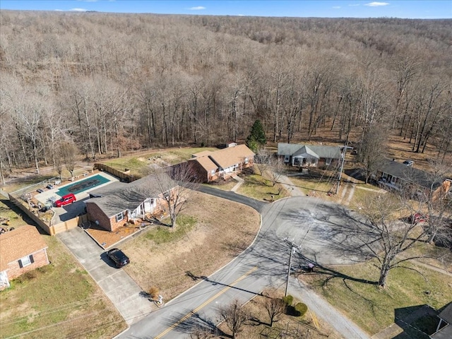 birds eye view of property with a wooded view