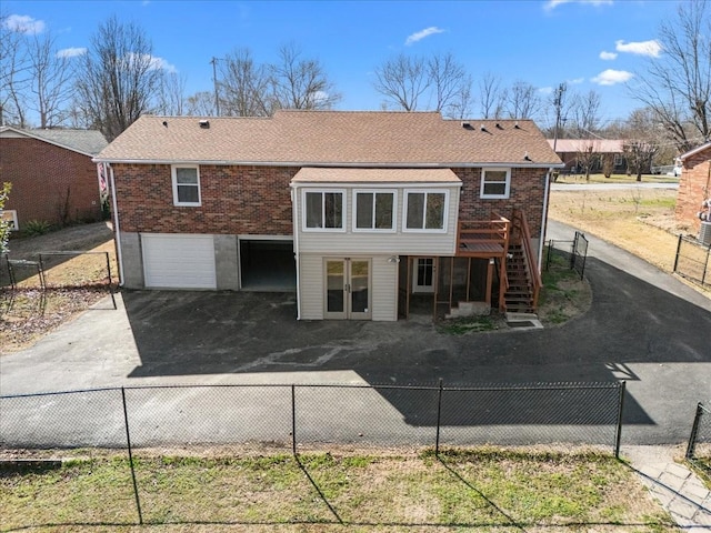 back of property featuring a fenced backyard and stairs