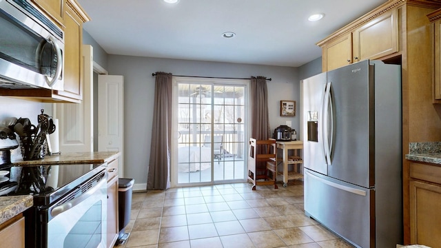 kitchen featuring stainless steel appliances, recessed lighting, and light tile patterned floors