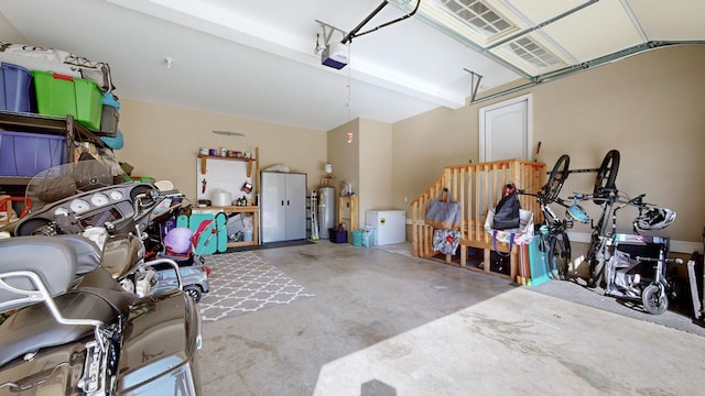 garage with water heater and a garage door opener