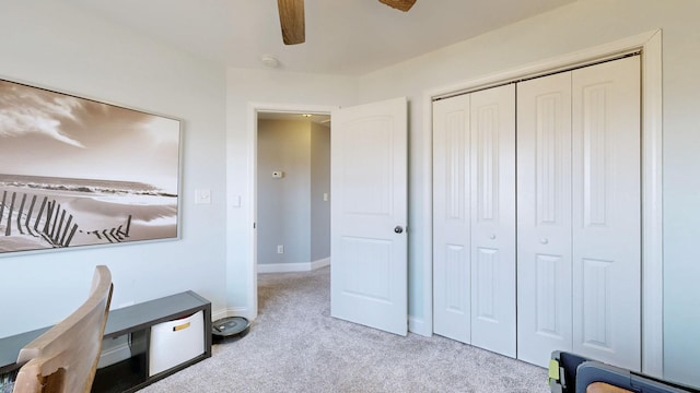 carpeted home office with a ceiling fan and baseboards