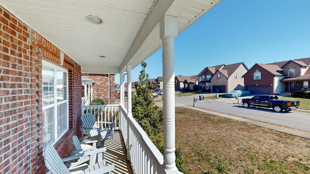 balcony with covered porch and a residential view