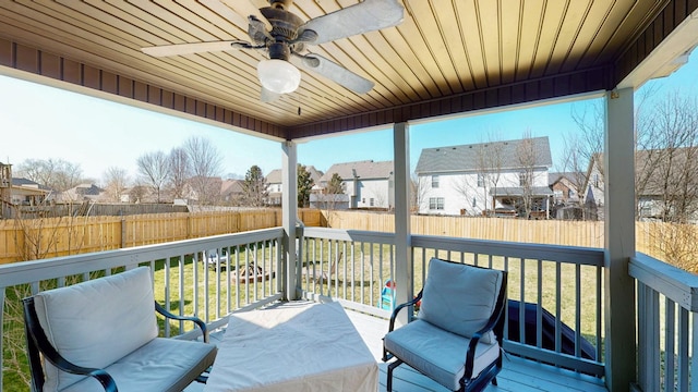 wooden deck featuring a fenced backyard, a residential view, and ceiling fan