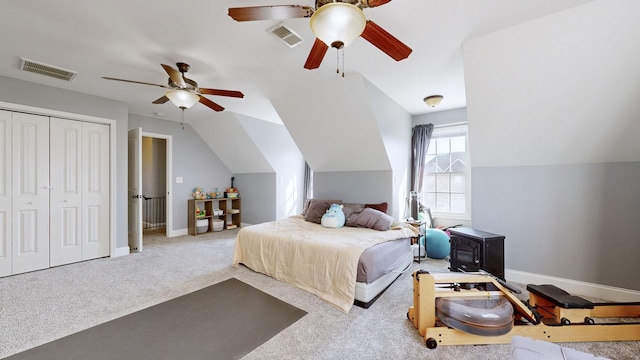 carpeted bedroom featuring lofted ceiling, visible vents, and baseboards