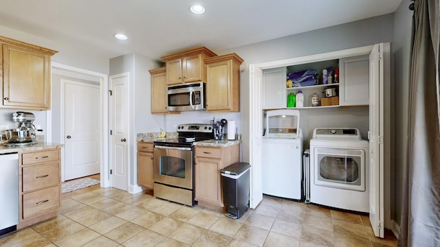 kitchen with washing machine and clothes dryer, recessed lighting, appliances with stainless steel finishes, light brown cabinets, and light stone countertops