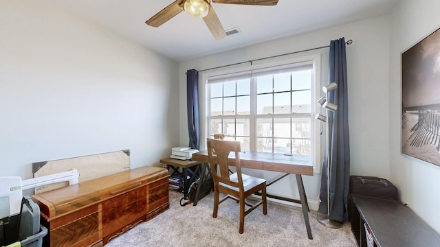 carpeted office space featuring visible vents and a ceiling fan