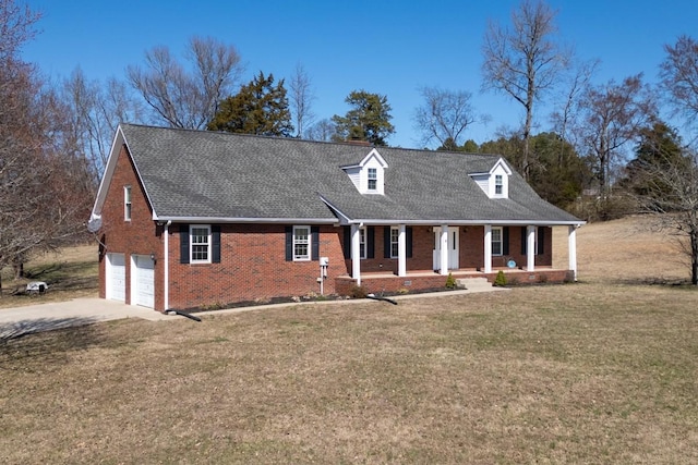 cape cod home featuring a porch, an attached garage, brick siding, concrete driveway, and a front yard