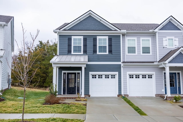 view of front of property with a garage, a front yard, and concrete driveway