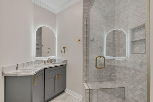 bathroom featuring vanity, baseboards, ornamental molding, tile patterned floors, and a stall shower