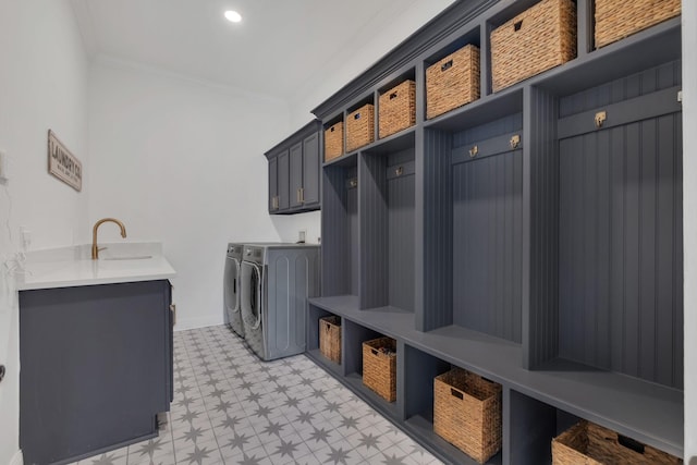 mudroom featuring recessed lighting, a sink, baseboards, ornamental molding, and washer and clothes dryer