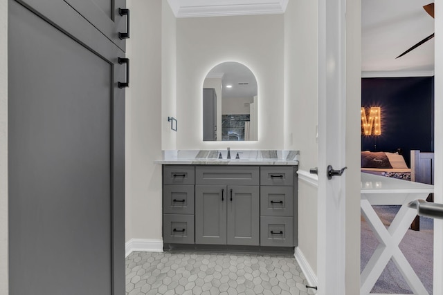 bathroom featuring crown molding, vanity, baseboards, and tile patterned floors