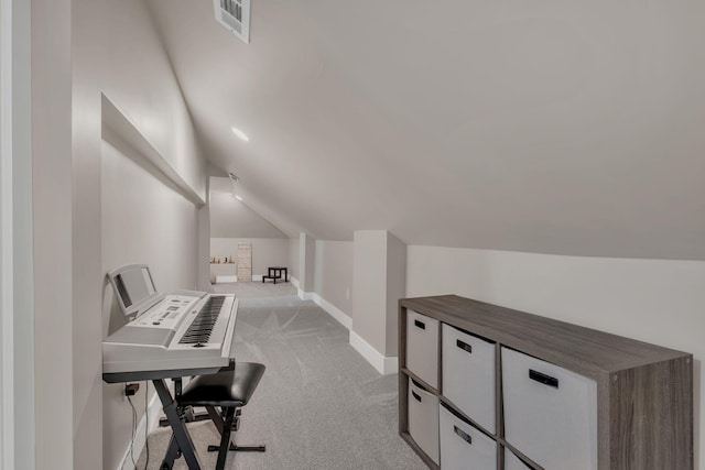 office with lofted ceiling, light carpet, visible vents, and baseboards