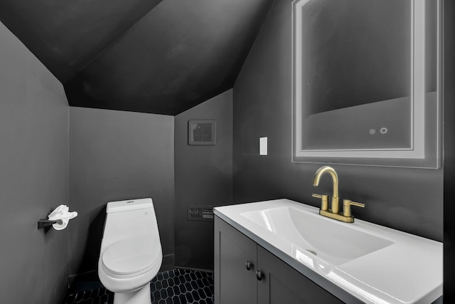 bathroom featuring lofted ceiling, visible vents, vanity, and toilet