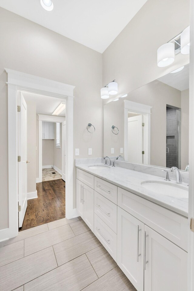 5704 Old Harding Pike, Nashville, TN 37205 - full bath with walk in shower, double vanity, a sink, and wood finished floors
