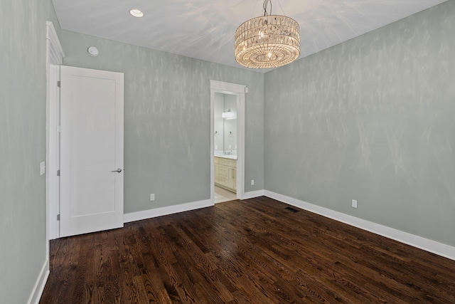 5704 Old Harding Pike, Nashville, TN 37205 - unfurnished bedroom with ensuite bath, a notable chandelier, baseboards, and wood finished floors