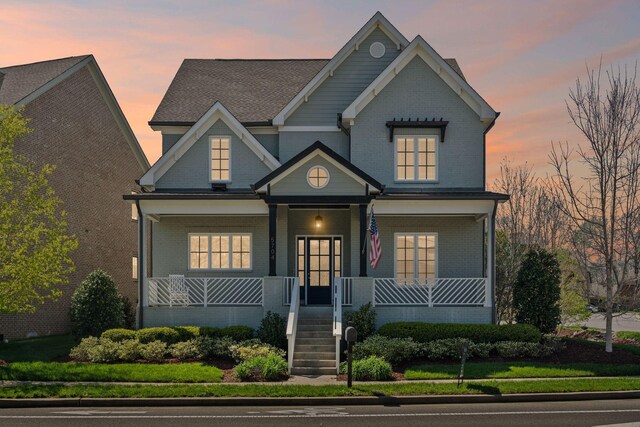 5704 Old Harding Pike, Nashville, TN 37205 - craftsman inspired home with stairs, a porch, and brick siding