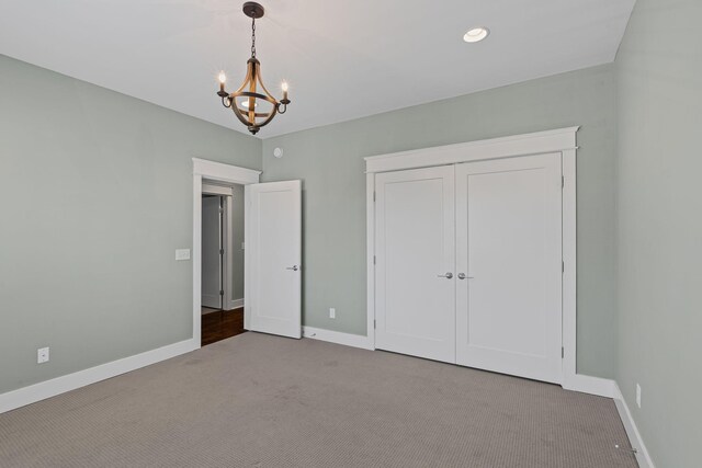 5704 Old Harding Pike, Nashville, TN 37205 - unfurnished bedroom with baseboards, a notable chandelier, a closet, and carpet