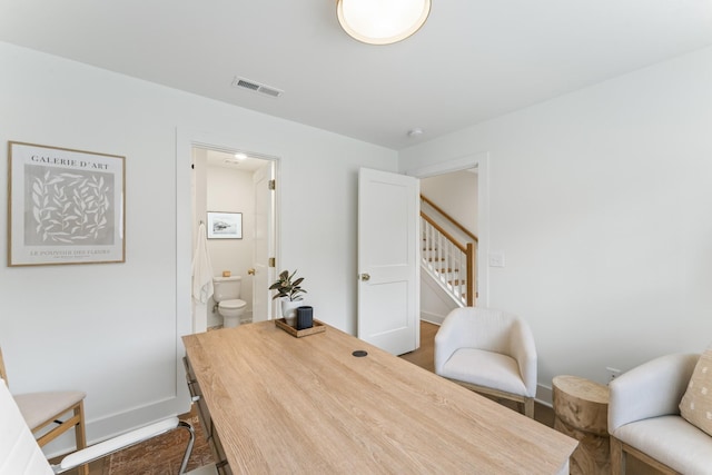 office space featuring visible vents and baseboards