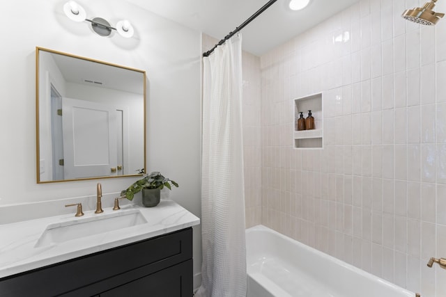 bathroom with visible vents, shower / bath combination with curtain, and vanity