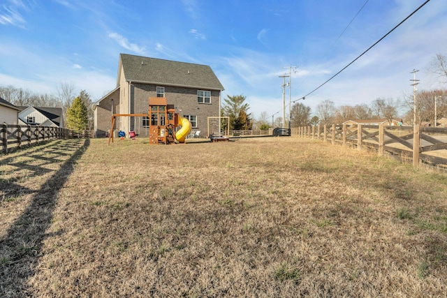 view of yard with a playground and a fenced backyard