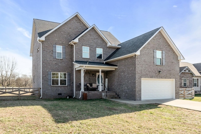 traditional-style home with brick siding, concrete driveway, a front yard, crawl space, and fence