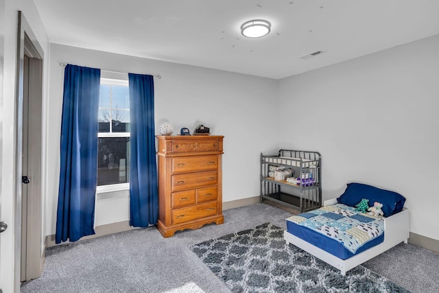 bedroom with carpet floors, visible vents, and baseboards