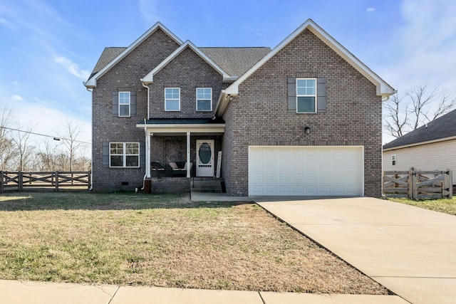 traditional home with driveway, a porch, fence, a front lawn, and brick siding