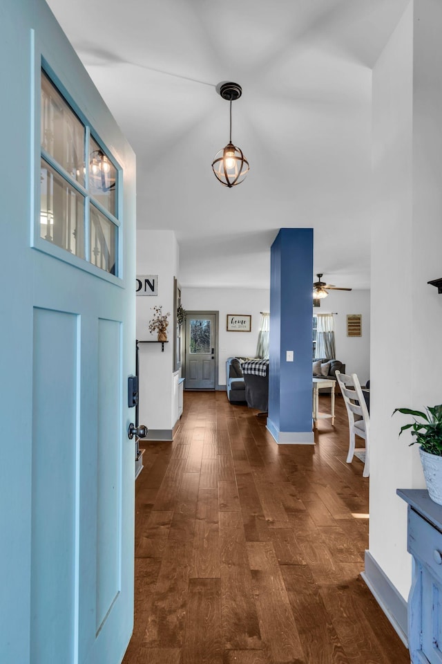 entrance foyer featuring dark wood-style floors, ceiling fan, and baseboards