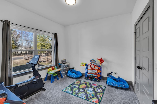 rec room with carpet floors and baseboards