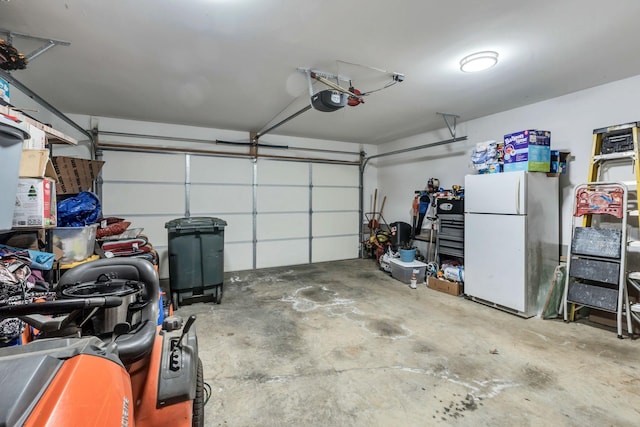 garage featuring a garage door opener and freestanding refrigerator