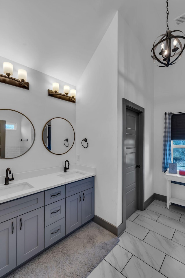 full bath featuring marble finish floor, visible vents, a sink, and double vanity