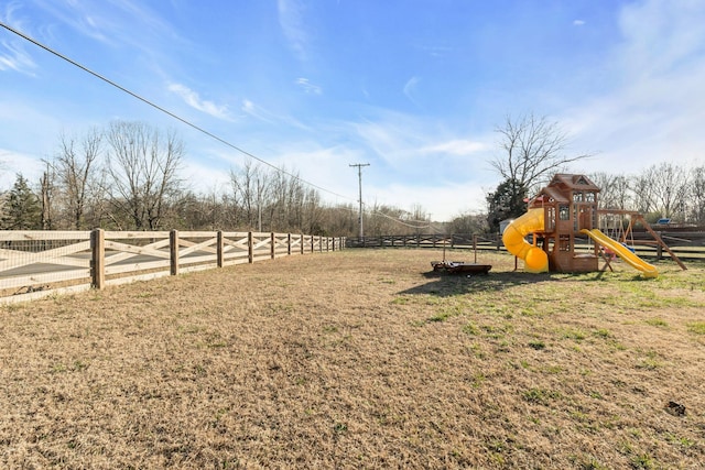 view of yard with a playground and fence